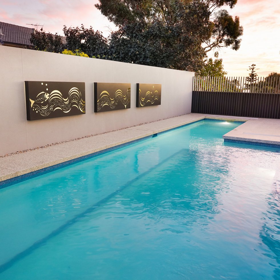 blue swimming pool and feature wall